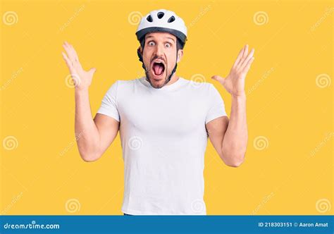 Young Handsome Man Wearing Bike Helmet Celebrating Crazy And Amazed For