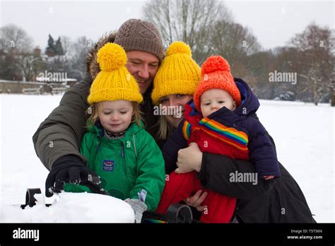 Family portrait in the snow, UK Stock Photo - Alamy