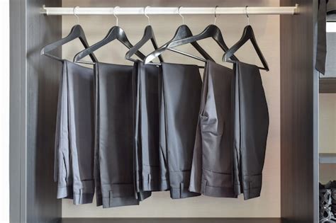 Premium Photo Row Of Black Pants Hangs In Wardrobe At Home