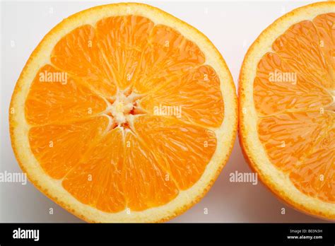 An Orange Cut In Half Showing One And A Half Orange Slices Stock Photo