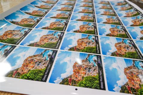 a table topped with pictures of buildings on it's sides and clouds in ...