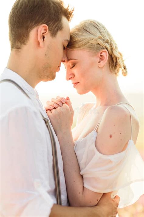 Beautiful Portrait Of Bride And Groom Hug Each Other Tender On Sunset