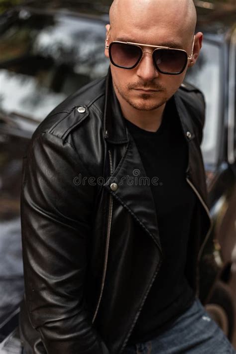 Portrait Handsome Bald Man With Beard In Sunglasses In Fashion Leather Jacket Near Modern Black