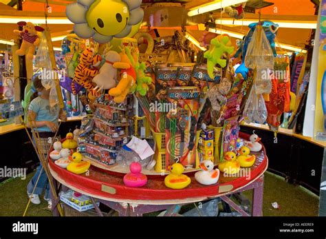 Hook a duck fairground stall with prizes including toys and goldfish ...