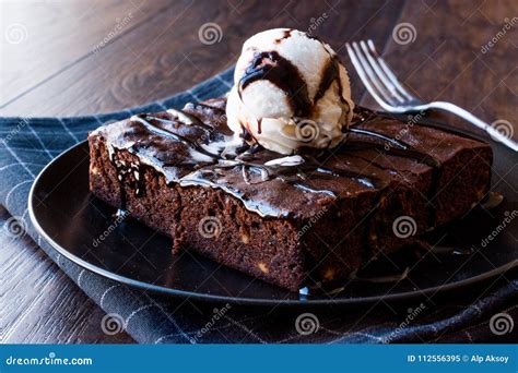 Chocolate Brownie with Ice Cream and Hazelnut Powder. Stock Image - Image of plate, cream: 112556395