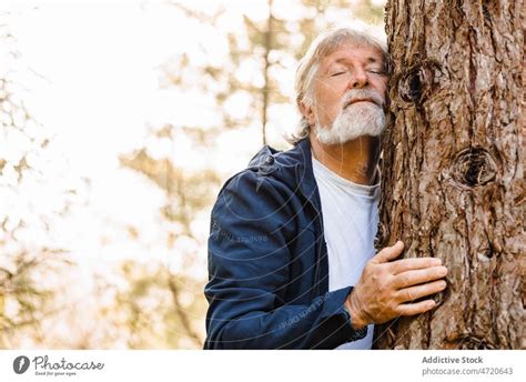 Naked Man Embracing Tree In Forest A Royalty Free Stock Photo From