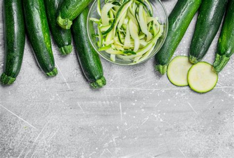 Pieces Of Zucchini In A Bowl And A Fresh Whole Zucchini Stock Photo