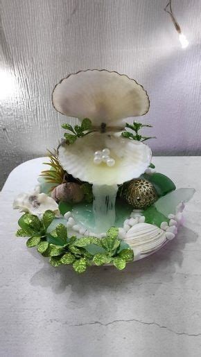 An Arrangement Of Seashells And Plants On A Table