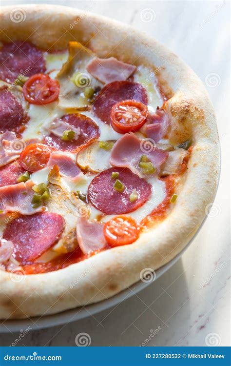 Whole Baked Neapolitan Pepperoni Pizza On A Table Stock Photo Image