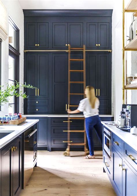 A Rolling Library Ladder Is The Secret To Getting More Kitchen Storage