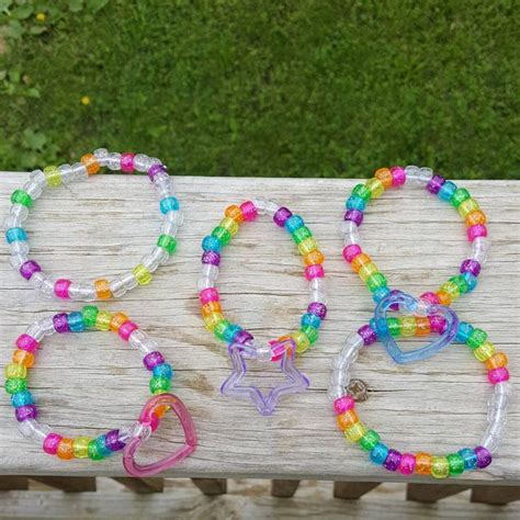 Three Bracelets Are Sitting On A Wooden Bench