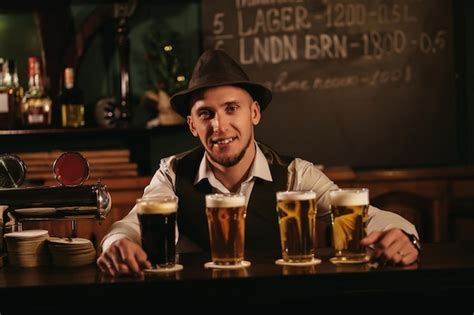 Camarero Sonriente Feliz En El Mostrador Del Bar Con Cuatro Vasos De