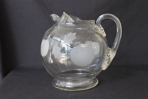 Vintage Clear Glass Ball Shaped Pitcher With Etched Pumpkins And Leaves And Ribbed Handle