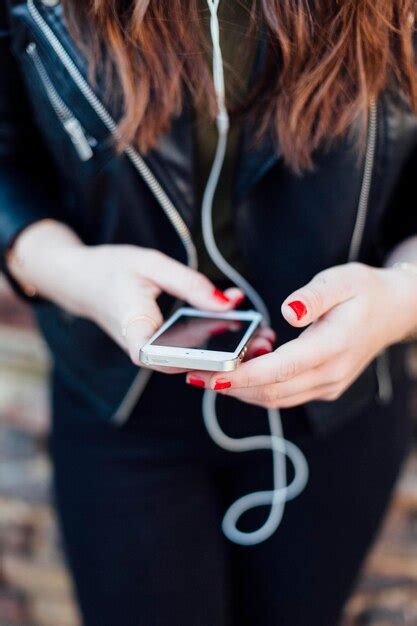 Premium Photo Close Up Of Female Hands Holding Mobile Phone