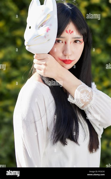 Young Japanese woman with fox mask Stock Photo - Alamy