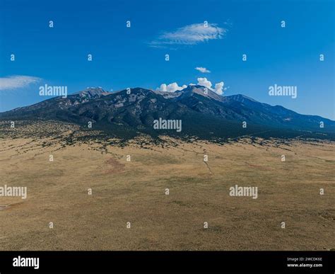 Vast plains stretch towards the imposing mountains under the Colorado sky Stock Photo - Alamy