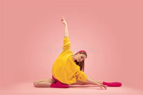 Portrait Of Young Beautiful Girl Female Ballet Dancer Training Isolated Over Pink Background