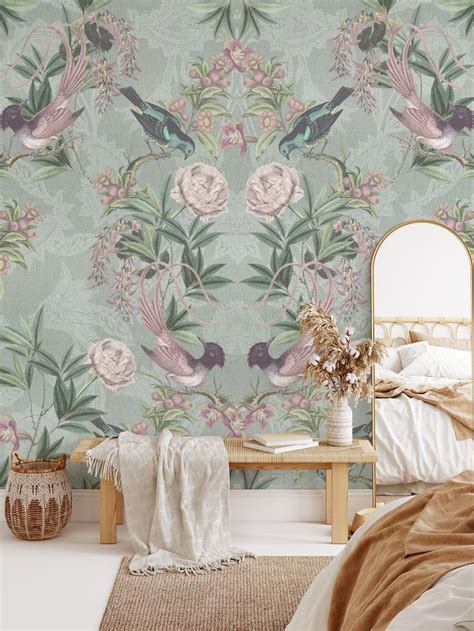 a bed room with a neatly made bed and a wallpapered background that has ...