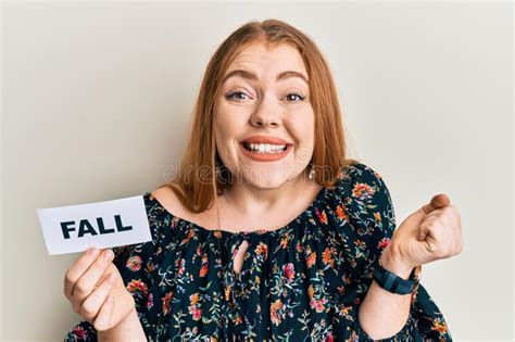 Young Beautiful Redhead Woman Holding Fall Word On Paper Screaming Proud Celebrating Victory