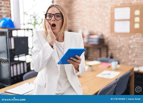 Young Caucasian Woman Working At The Office Wearing Glasses Afraid And Shocked Surprise And