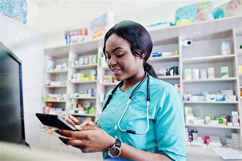 African American Pharmacist Cashier Working In Drugstore At Hospital