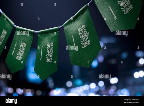 A Garland Of Saudi Arabia National Flags On An Abstract Blurred