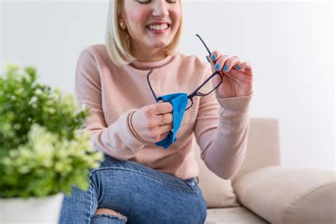 Woman Cleaning Reading Glasses With Cloth Women Hand Cleaning Glasses Lens With Blue Cloth