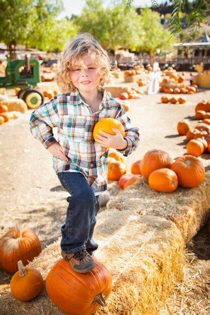 Premium Photo Little Boy Standing In A Rustic Ranch Setting At The