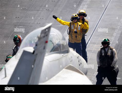 A Sailor Signals To A Jet To Move Into Position Stock Photo Alamy