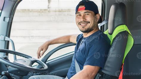 The Asian Truck Driver Man Smiling Happily Inside The Front Of The