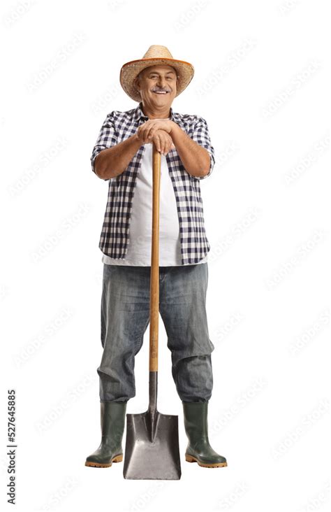 Foto Full Length Portrait Of A Mature Farmer Leaning On A Shovel And