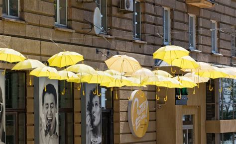 Yellow Umbrellas Suspended On Ropes At The Entrance To The Theme