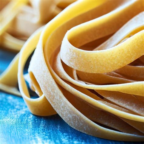 Premium AI Image Close Up Of A Raw Dry Italian Pasta Fettuccine On