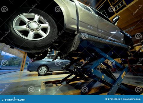 Car on Hydraulic Lift in Auto Repair Shop Editorial Image - Image of ...