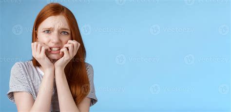 Worried uncomfortable scared young panicking redhead young girl feeling