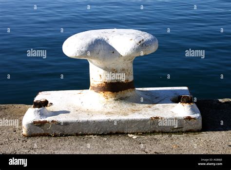 White Bollard Against Blue Water Horizontal Bapdb8572 Stock Photo Alamy