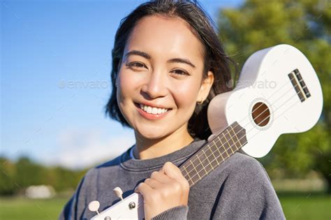 Portrait Of Beautiful Smiling Girl With Ukulele Asian Woman With