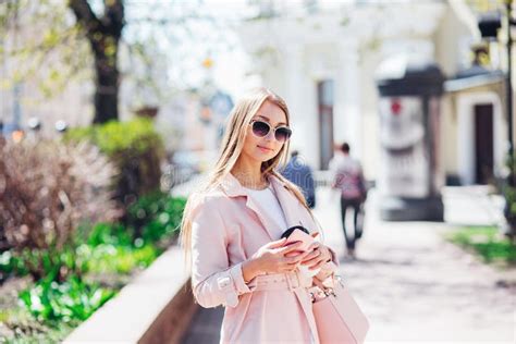 Upper Class Woman Fashionable Woman Texting Outdoors Fashion Woman In A Sunglasses And Pink