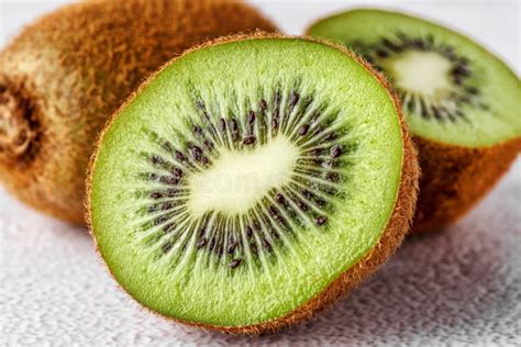 Slices Of Kiwi Fruit On Kiwi Background Fresh Kiwis On Wooden Ground