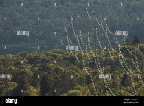 High Voltage Electric Pylon And Electrical Wire With Grey Sky And White