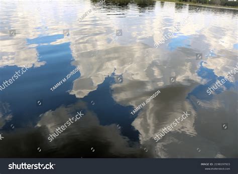 reflections blue sky white clouds clear stock photo