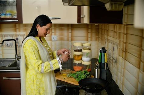 Premium Photo Happy Woman Cook In Her Kitchen Indian Pakistani Model