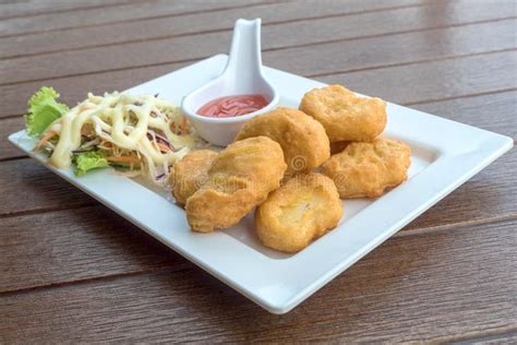 Close Up Of Delicious Crispy Fried Chicken Nuggets With Sauce And Salad