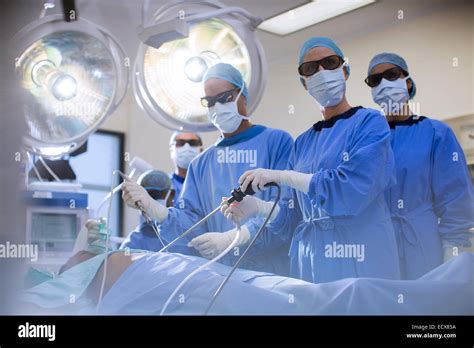 Team Of Doctors Performing Laparoscopic Surgery In Operating Theater