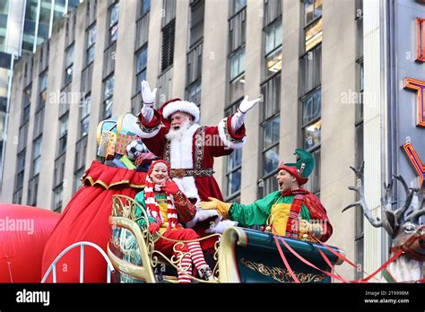 Santa Claus Waves To The Crowds From On Top Of The Macys Santas