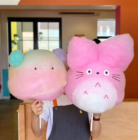 a person holding two large stuffed animals in their hands