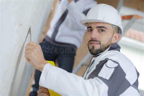 Construction Worker With Wall Plastering Tools Renovating Apartment