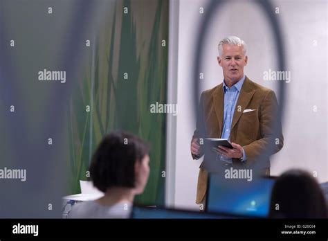 Handsome Mature Teacher And Students In Computer Lab Classroom Stock Photo Alamy