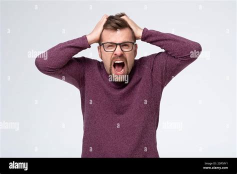 Mature Caucasian Man With Glasses In Pain And Despair Holding Hands On