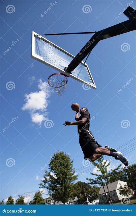 Slam Dunking a Basketball stock image. Image of park - 34127331